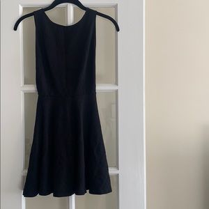 black mini dress with open back and sides.
